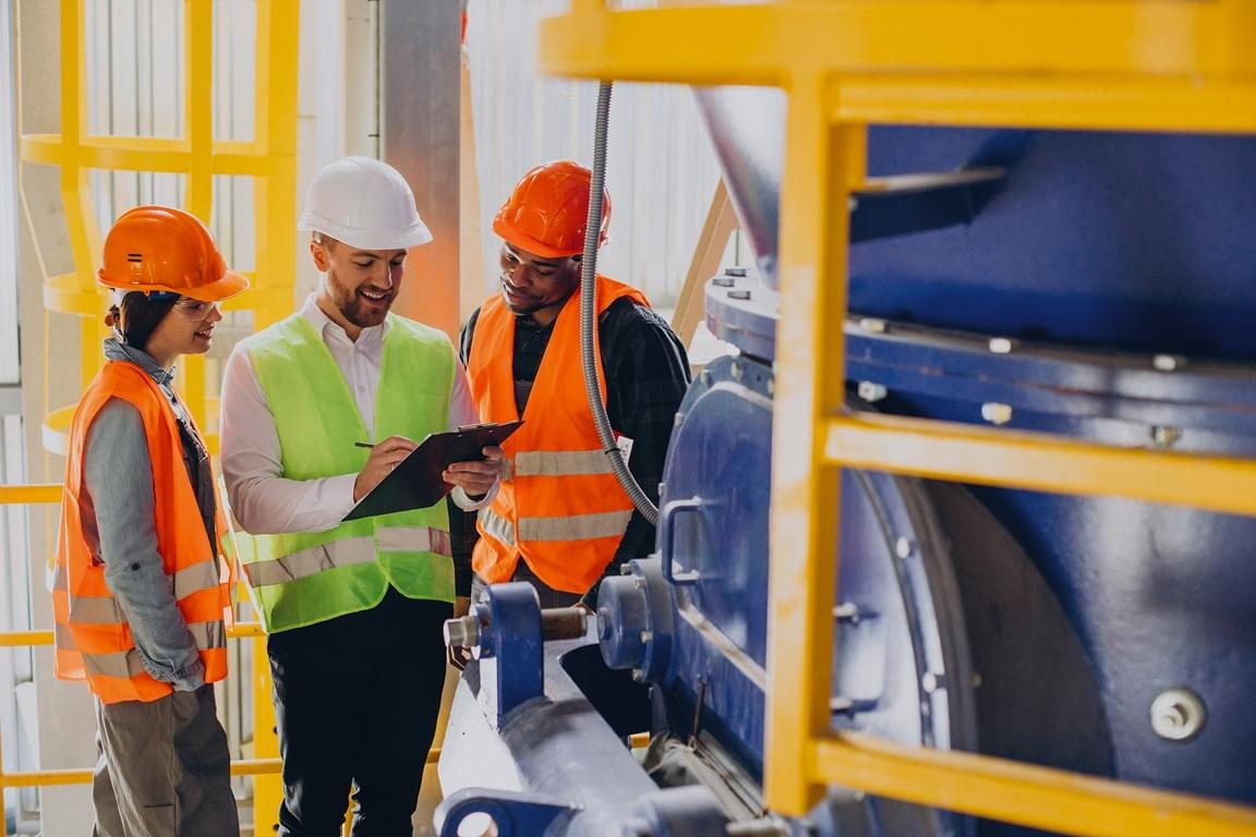 Health and safety consultants inspecting industrial equipment during workplace safety consulting service